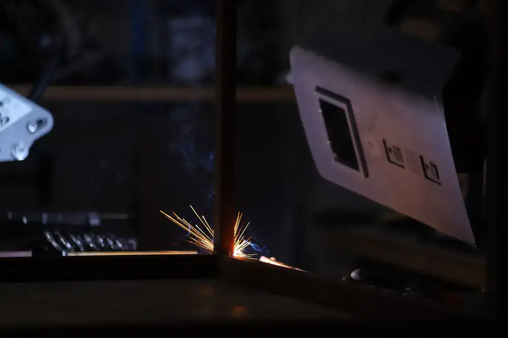 Sparks flying as a steel bicycle frame is welded in the workshop