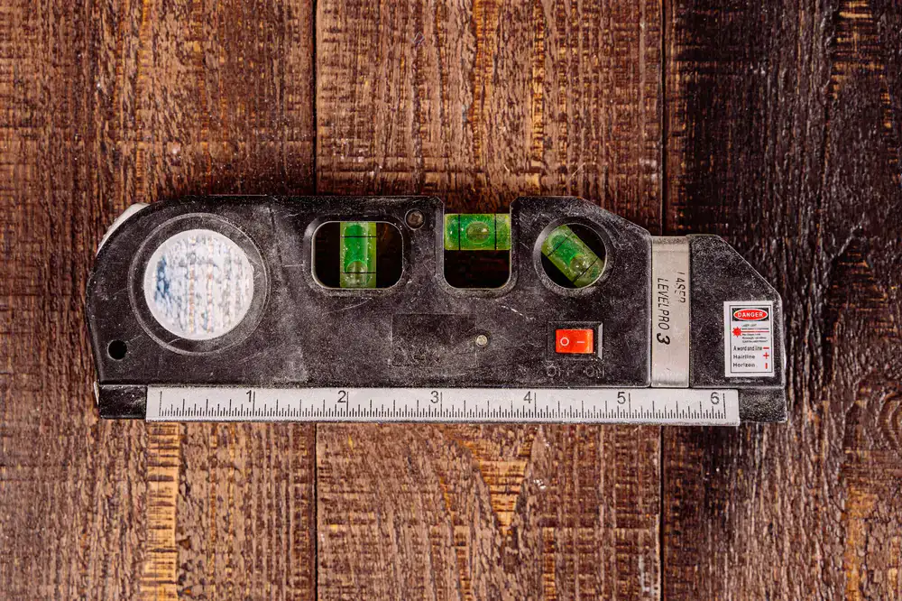 Precision alignment tools and measuring equipment on a stained wood bench